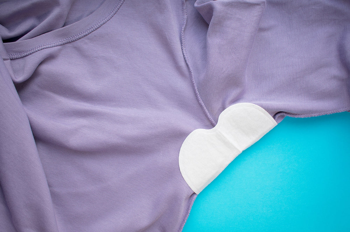 Underarm sweat pads worn on the inside of a shirt