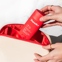 Open Duradry Travel Bag packed with antiperspirant body wipes, deodorant stick, body cleanser and sweat minimizing gel